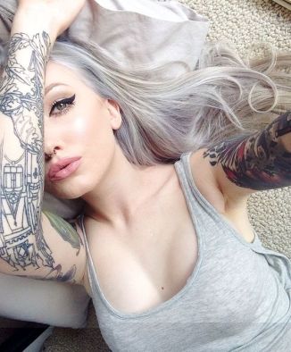 Inked Girl with grey hair and arm tattoos
